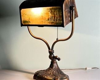 CAST BRASS DESK LAMP  |                                                                   Having a bankers lamp form shade with reverse painted glass panels (eglomise) suspended on a harp, no apparent maker - l. 11 x w. 7 x h. 15 in.