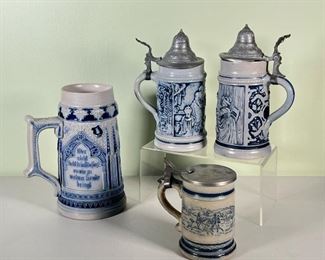 (4pc) METTLACH STEINS  |  Four blue and grey stoneware Mettlach steins from Germany, with pewter lids (one missing); depicting drinking scenes, horse scenes, and castle scenes - h. 8 x dia. 4.5 in. (1L stein)