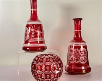 (3pc) CRANBERRY GLASS  |  Cut cranberry glass, including a pair of point bottles and a round vase - h. 10.25 in. (tallest)