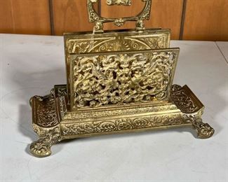 BRASS DESK ORGANIZER  |  Brass letter holder with two open work dividers for papers and letters, a medial scrollwork handle, side trays, and four feet - l. 10 x w. 5 x h. 8 in.
