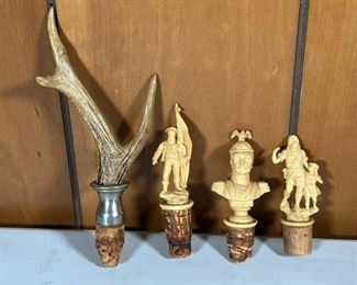CARVED BOTTLE STOPPERS  |  Three carved bottle stoppers from Bad Kissingen, Germany and a small antler stopper - l. 8 in. (antler stopper)
