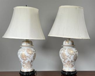 (2pc) PAIR GILT PORCELAIN LAMPS  |  Of ginger jar form, decorated with blossoming flowers, on wood stands; porcelain / vase h. 11.5 in. - overall h. 23.5. x dia. 14 in. (each, with shade)