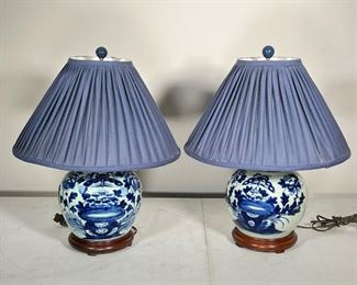 (2pc) PAIR GINGER JAR LAMPS  |  Pair of Asian blue & white ginger jar lamps on wooden base; glazed ceramic with blue floral motif; matching blue shades and finials - h. 21 x dia. 20 in. (overall with shade)