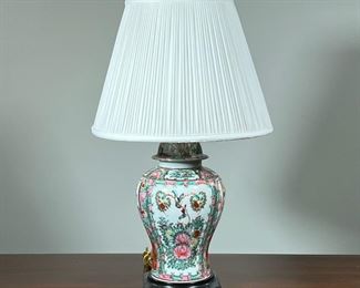 GILT ENAMELED LAMP  |  Chinese famille rose bulbous jar convereted into a lamp, decorated with scenes in reserves and flour and scroll devices - h. 28.5 x dia. 16 in. (overall with shade)