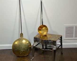 (3pc) BRASS ITEMS  |  Brass foot stool with open work accents and heart shaped holes; a coal bed warmer; and a small brass pot with a long handle - l. 14 x w. 10 x h. 12 in. (stool)
