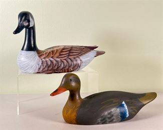 (2pc) HAND PAINTED DECOYS  |  A pair of hand painted wooden waterfowl decoys; one Canadian goose with glass eyes, and one duck - l. 9 x w. 4 x h. 6 in. (goose)