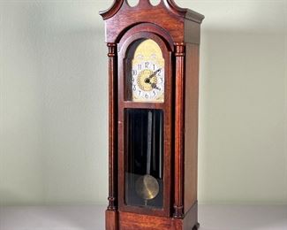C.J. HUG CO. MINI GRANDFATHER CLOCK  |  Model No. 500, the face marked "Imperial / Westminster Chimes" with five hanging tubes electrically operated, in a wood case with broken pediment - l. 6.25 x w. 5.25 x h. 18.5 in.

