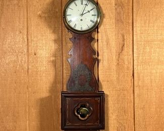 VINTAGE BANJO CLOCK  |  Wooden banjo clock with John W. Bennett Clockmaker label to interior, having Roman numeral markers - l. 9.5 x w. 3.5 x h. 30 in.