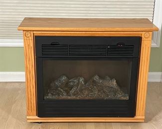 ELECTRIC FIREPLACE  |  Heat Surge Electric Fireplace Model ADL-2000M-X; with placard that reads "Hand-Built by Amish Craftsmen / Made in USA - l. 32 x w. 12 x h. 25 in. (overall)
