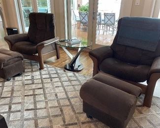 (2) Stressless brand recliners with storage ottomans   
