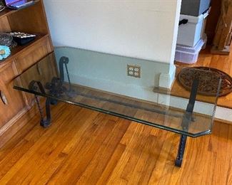 Glass topped table with iron base.