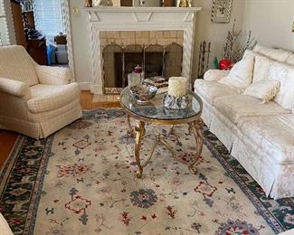 Neat rug and cool brass and glass table.