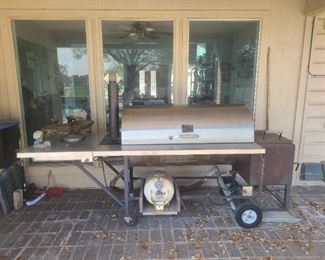 Custom-made propane w/a propane burner on the side BBQ pit. Attachment for charcoal cooking, rotisserie, & satay grilling.  All interior racks are stainless steel. Includes a spare propane barrel