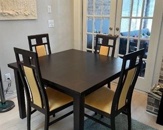 Ansager Mobler Mid Century Danish Walnut Hidden Leaf Dining Table. This table measures: 35.5" x 35.5" x 30" high as shown.  Includes 6 chairs and table pads.