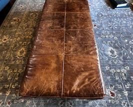 $500 USD     Michael Weiss Leather Top Ottoman/CoffeeTable/Bench LP162-3      Description:  A large scale good looking and useful size brown tufted leather ottoman with brass nail head trim on the skirt. Raised on brown ta[ered column legs on brass casters. 

Dimensions: 59 x 26 x 18 in

Condition: Please see all detail photos. There is some wear at the connection of the legs to the lower shelf of the Ottoman and expected wear in an even patina overall, slight scrapes to the legs with one area that has had puppy damage.

Location: Local pick up Portland, OR 97068.  Shipper suggestions available upon request. PICK UP AVAILABLE AFTER MARCH 15TH.      https://goodbyhello.com/products/copy-of-pair-of-ethan-allen-occasional-chairs-lp162-2?_pos=2&_sid=fdf2103f4&_ss=r