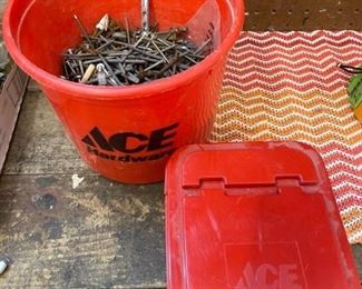 Bucket of miscellaneous nails, screws, bolts, and miscellaneous hardware, and empty plastic screw box
