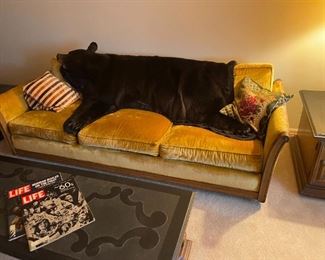 . . . mid-century gold couch with bearskin rug!