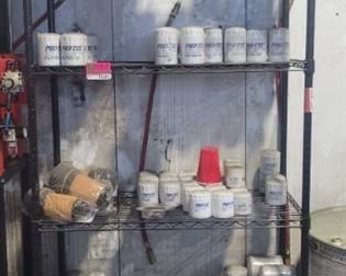 Shelf of Pro-Tec Oil Filters and Automotive Tools