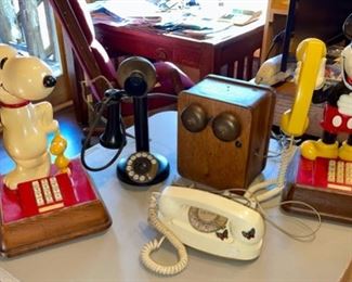 selection of phones - Snoopy, vintage candlestick phone and ringer box, Mickey Mouse, rotary phone