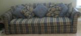 Plaid studio sofa with matching throw pillows