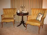 Pair French Provencial Tufted Back chairs show with a Mahogany Drum Table