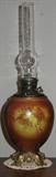 Antique Oil Lamp with Cherub hanging Floral Garland on Painted Milk Glass Font."Made in United States of America" is the only marking.