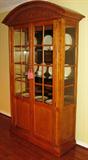 Century Furniture Industries China Cabinet with Bonnet top display/china cabinet with acanthus leaf carving, framed beveled glass doors, adjustable plate grooved glass shelves, tinted "solar bronze" Mirror back, Rheostate Lighting, two door base with shelf & drawer. Solid oak construction. ( 15 1/2" D x 56" W x 88" H)