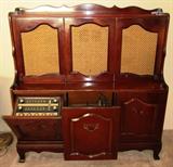 Very unusual RCA Victor Stereophonic Hi-Fidelity System in a Cherry French Provincial Style . This is the most unusual Stereo I have ever seen. The top section are speakers. On the bottom the left side has a drop-down AM/FM Radio, Center is the Phonograph, Right is the Record Album Storage