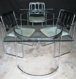 Mid-Century Modern Table;  Beveled Glass Top is supported by 2 Chrome  Crescent Shaped Pedestals .  Also shown are Mid-Century Chromecraft Chairs with Gray Lucite Backs.