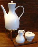 Hall China Ernest Sohn Designed Mid-Century Modern Coffee Carafe with Metal Stand, Sugar w/Lid and Creamer on Wood Tray
This large white ceramic coffee pot is marked "HALL - MADE IN USA"
Tall aprx. 11"....6" dia. base.
A great mid century look