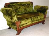 Antique Victorian Lounging Sofa with Wood Trim and Green Velvet Uphostery.  The Arms are adjust to 2 position.