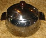 Vintage West Bend Penguin Ice Bucket w/ Bakelite Handles Insulated Server. It is an insulated covered bucket so you can use it for cold items as well as hot foods. The server measures 8 inches tall to the top of the lid knob and 10 1/2 inches across handle to handle. These were very popular in the 1950's and 60's so if you are shooting for a mid century modern decor this will fit right in.