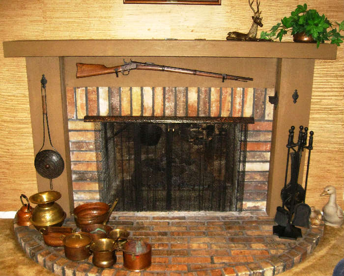 Fireplace with Antique Gun and collecrtion of brass & copper