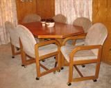 Oak Finish Octogan Table w/6 Arm Chairs on casters