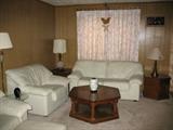 Leatherette Sofa and Easy Chair. 2nd Easy Chair with Ottoman not show. Large Hexagon Oak Finish Coffee Table