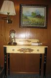 Hitchcock Painted Writing Table Shown with brass adjustable arm wall lamp. original work of art country landscape and an Anniversary Clock on writing table.