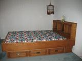 Oak Platform Queen Bed w/Lighted Bookcase Headboard. The base has 6 Drawers