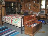 Black Tubular Iron Bed with Handmade Quilt and Cedar Chest