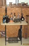 Wrought Iron Sewing Machine Base with Table Top. Show with various Liquor Bottles and misc bar items.