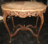 Great Antique veneered top Occassional Table with an ornately carved apron and cabriole legs with cross stretchers and center carved fenial.