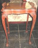 One of two Beautiful end tables. Tables are raised on delicate cabriole legs with a faux tray table top with glass insert.