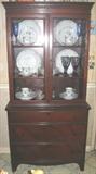 Small Double door Duncan Phyfe Style China Cabinet on bracket feet and 3 Drawers. China Cabinet is shown with a beutiful set of Mikasa Dinnerware