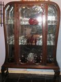 A Rare Elegant Beauty; Bombay shape mirrored back china cabinet with side and front glass panels. Center door has bevel glass. Acanthus-carved cabriole legs. ending on claw-and-ball feet. Constructed of solid and veneer mahgany. Appears to have original finish, mirror, and glass. 69"H x 48"W x 16"D