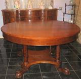 Antique Mahogany 54" round table w/leaf. Supported on 4 Column legs extended to a platform base and ending in a squashed 4.5" Claw-and-Ball foot.