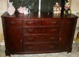 Mahogany Duncan Phyfe Style Sideboard. Four Center drawers flanked by silver cloth lined drawer above a doored cabinet.