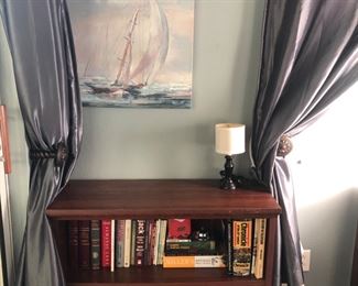 Main Level/Queen Bedroom 
Small bookcase.  Painting of sailboat