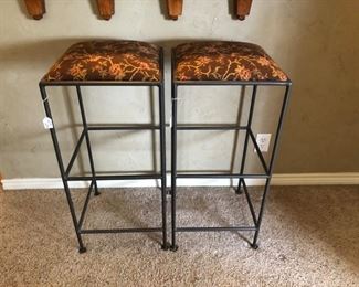 A pair of iron bar stools