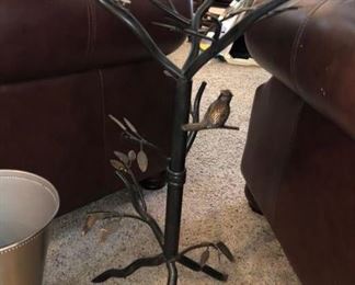 That's a bird on that branch! There are a pair of these iron tables