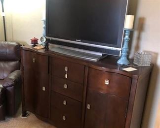 Sylvania flat screen TV and a dresser