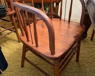One of four antique curved back chairs